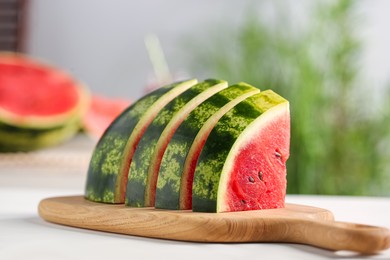Slices of delicious ripe watermelon on white wooden table indoors, closeup