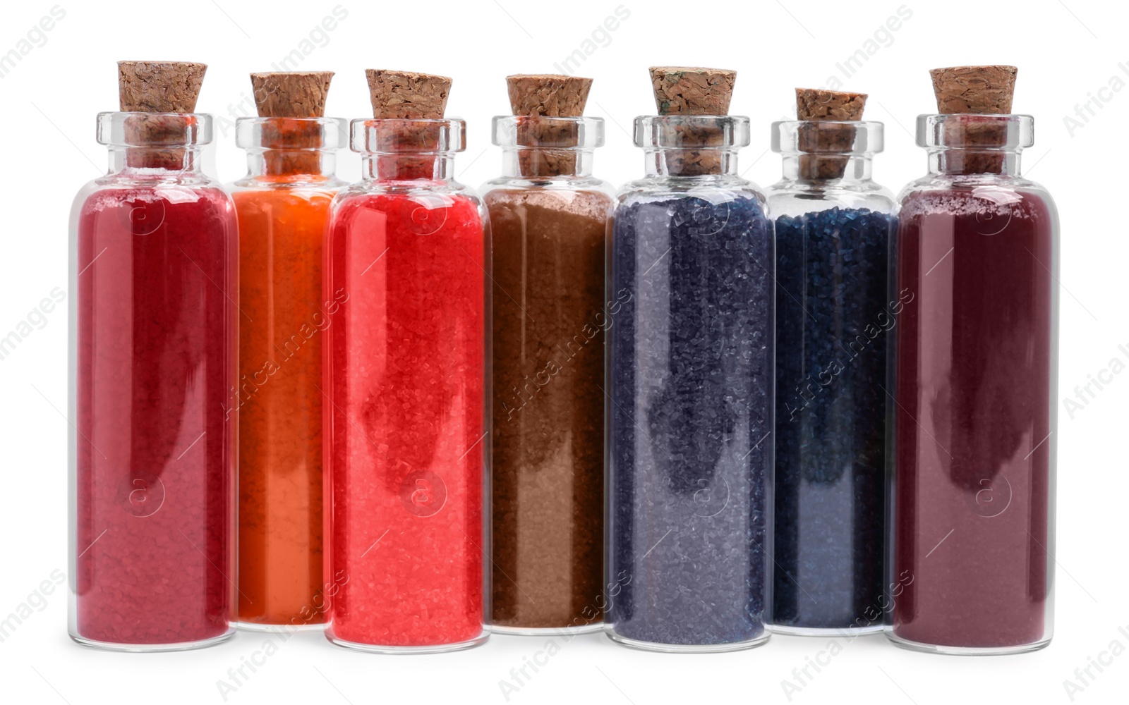 Photo of Glass bottles of different food coloring isolated on white