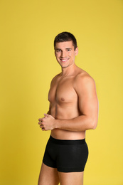 Photo of Man with sexy body on yellow background