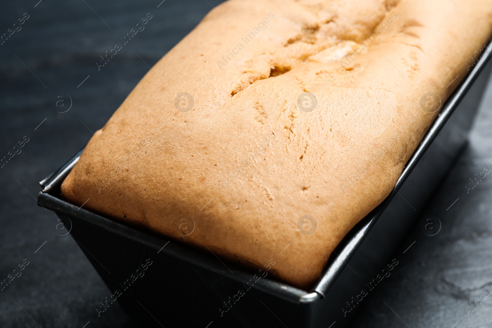 Photo of Tasty pear bread on black table, closeup. Homemade cake