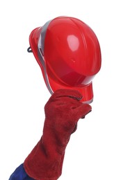 Photo of Young man holding red hardhat on white background, closeup. Safety equipment