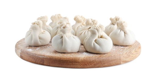 Photo of Wooden board with uncooked khinkali (dumplings) isolated on white. Georgian cuisine