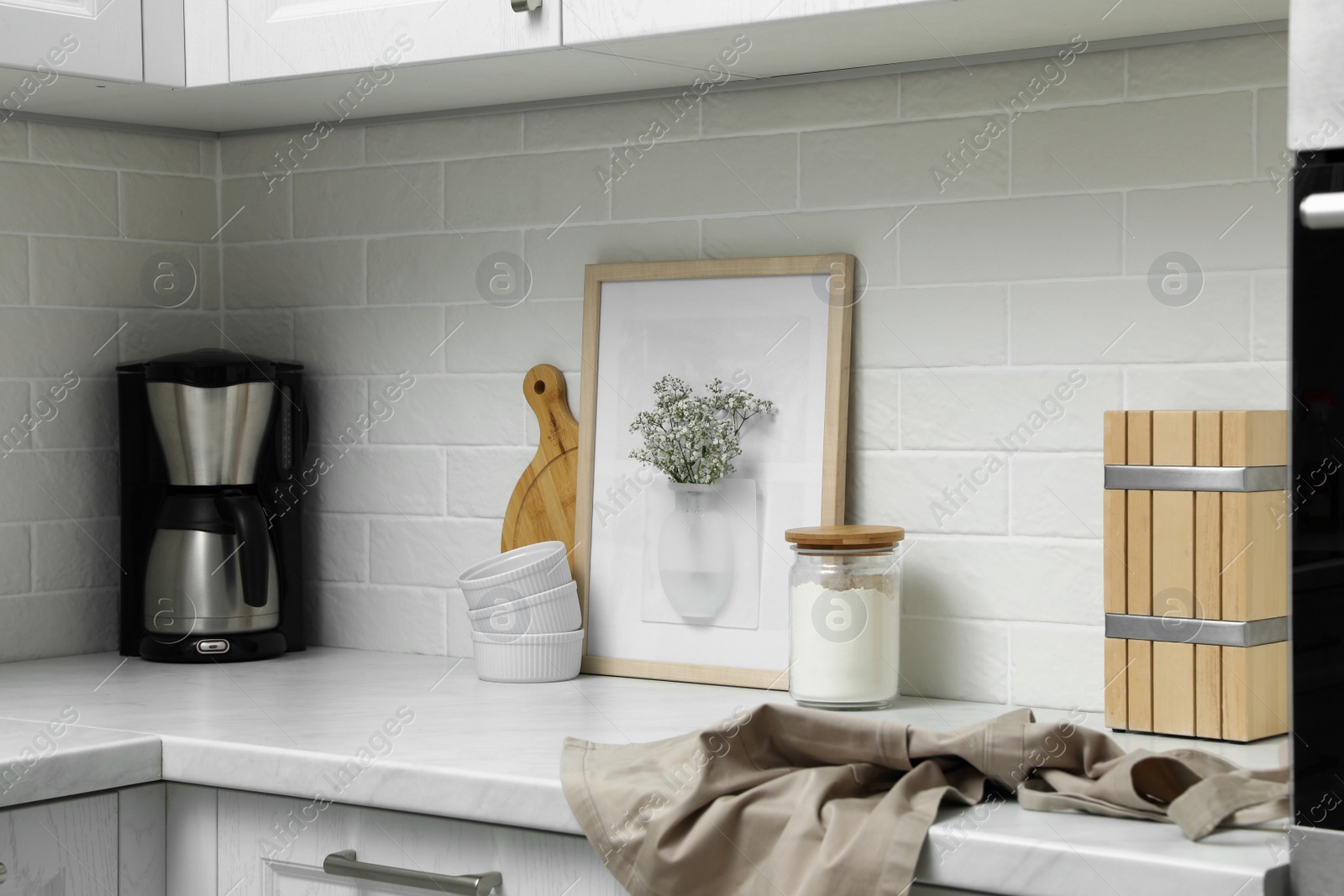 Photo of Silicone vase with flowers on countertop in kitchen