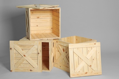 Photo of Group of wooden crates on grey background