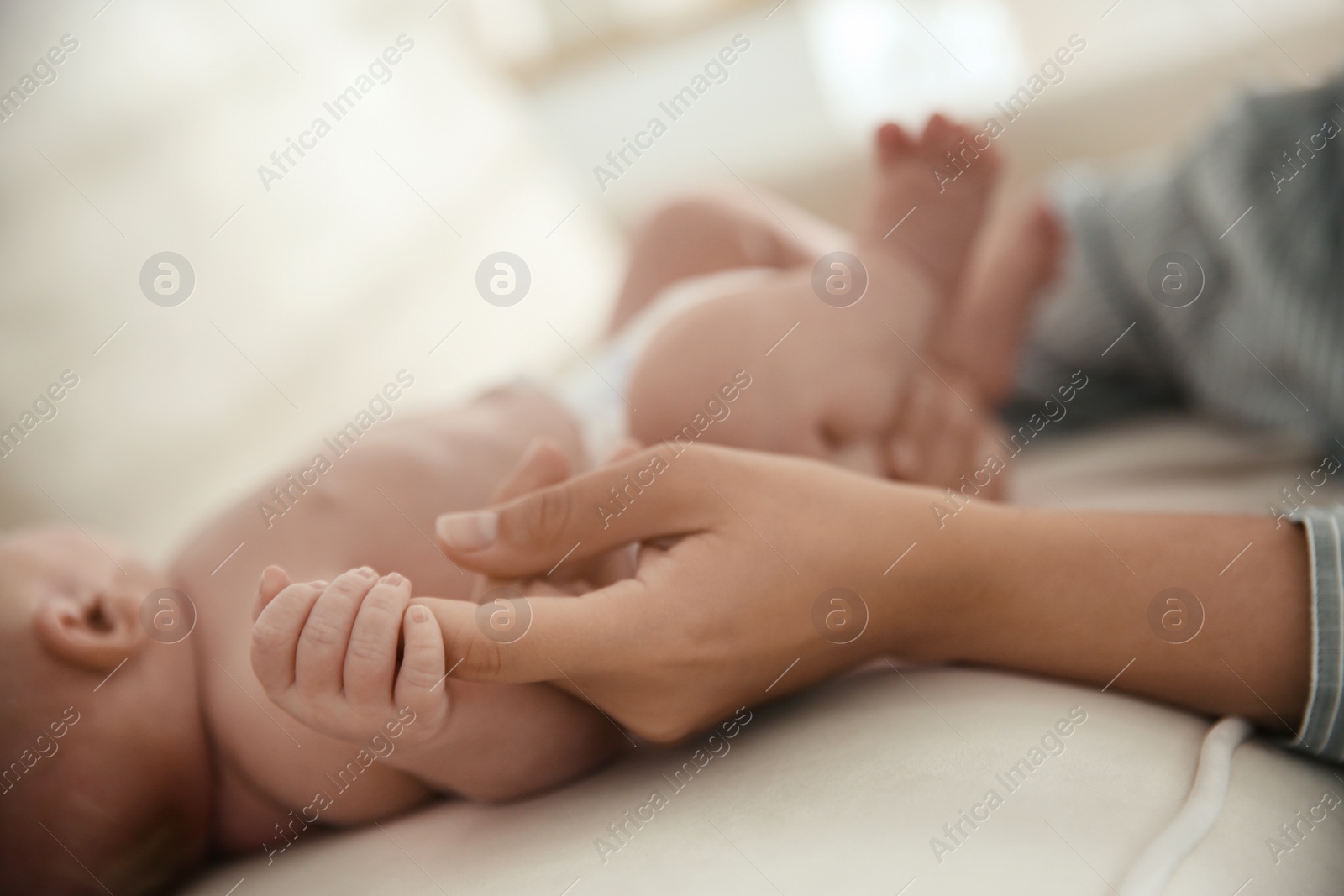 Photo of Mother with her newborn baby at home, closeup