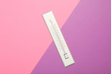 Photo of Weather thermometer on color background, top view