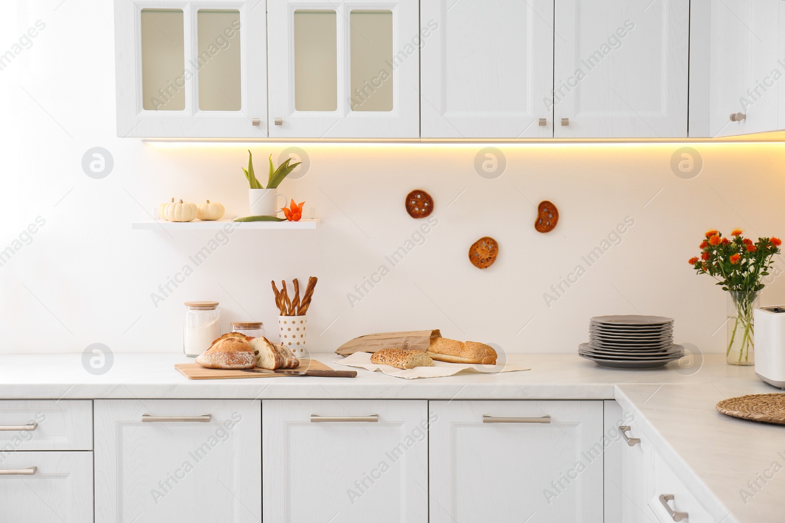 Photo of Modern kitchen interior with products on counter