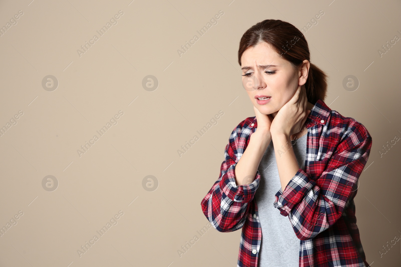 Photo of Woman suffering from cough on color background. Space for text