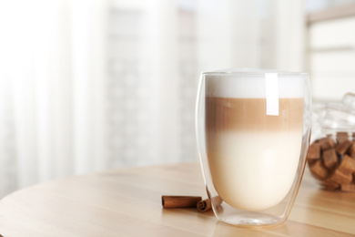 Delicious latte macchiato on wooden table indoors. Space for text