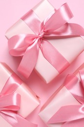 Beautiful gift boxes on pink background, flat lay