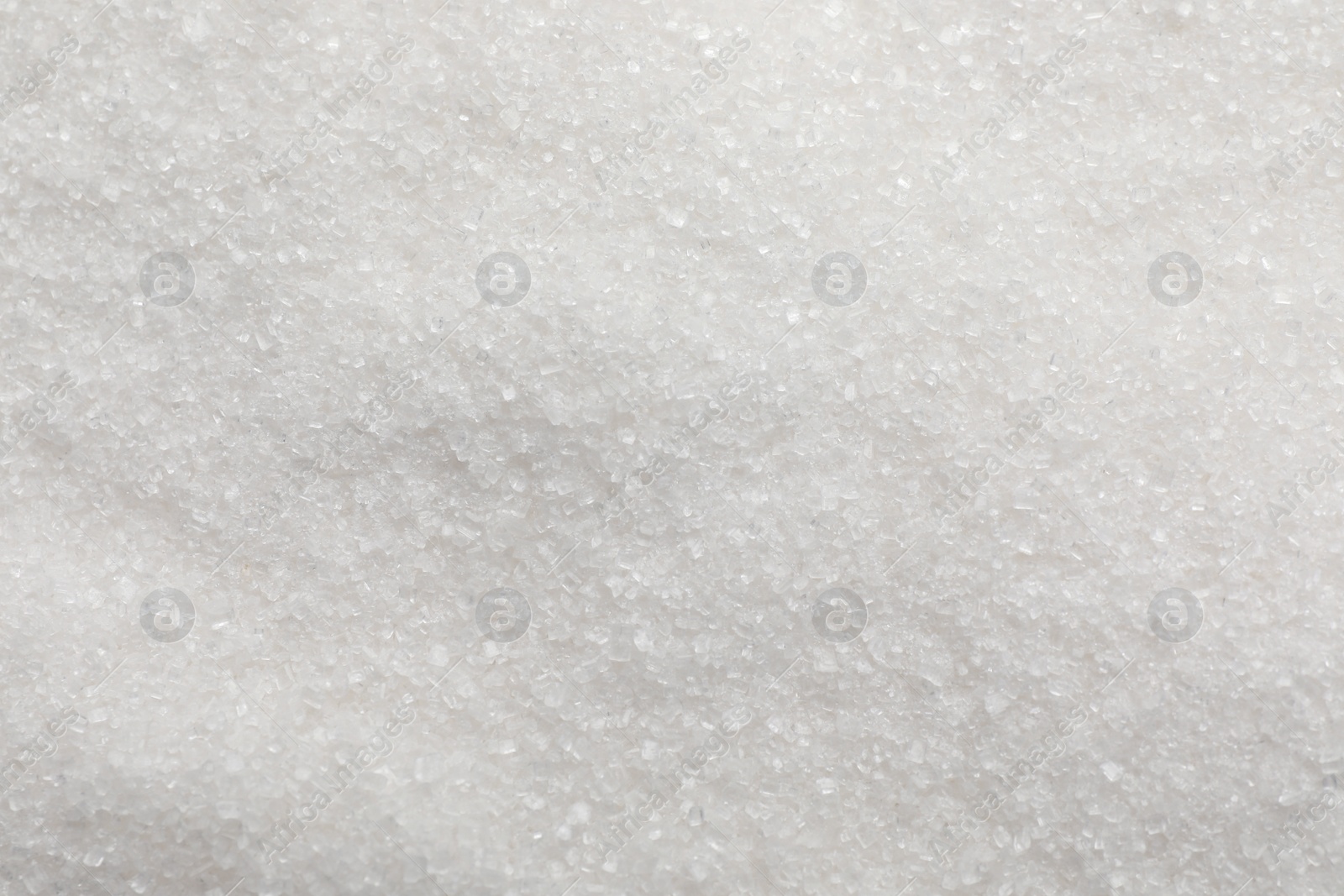 Photo of Sweet granulated sugar as background, top view