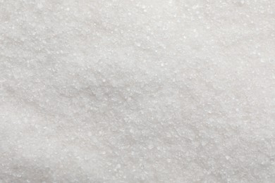 Photo of Sweet granulated sugar as background, top view