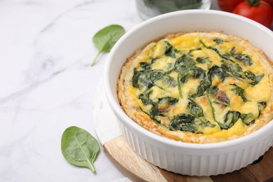 Photo of Delicious pie with spinach on white marble table, closeup