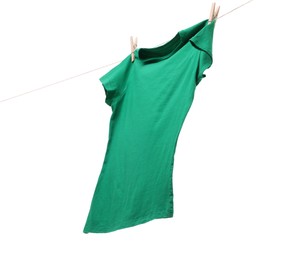 One green t-shirt drying on washing line isolated on white