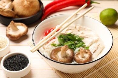 Delicious ramen with meat and ingredients on wooden table, closeup. Noodle soup