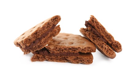 Broken tasty chocolate sandwich cookies with cream on white background