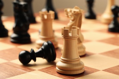 Photo of Wooden chessboard with game pieces, closeup view