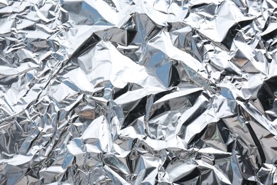 Photo of Crumpled silver foil as background, closeup view