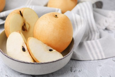 Photo of Delicious apple pears on white textured table, closeup