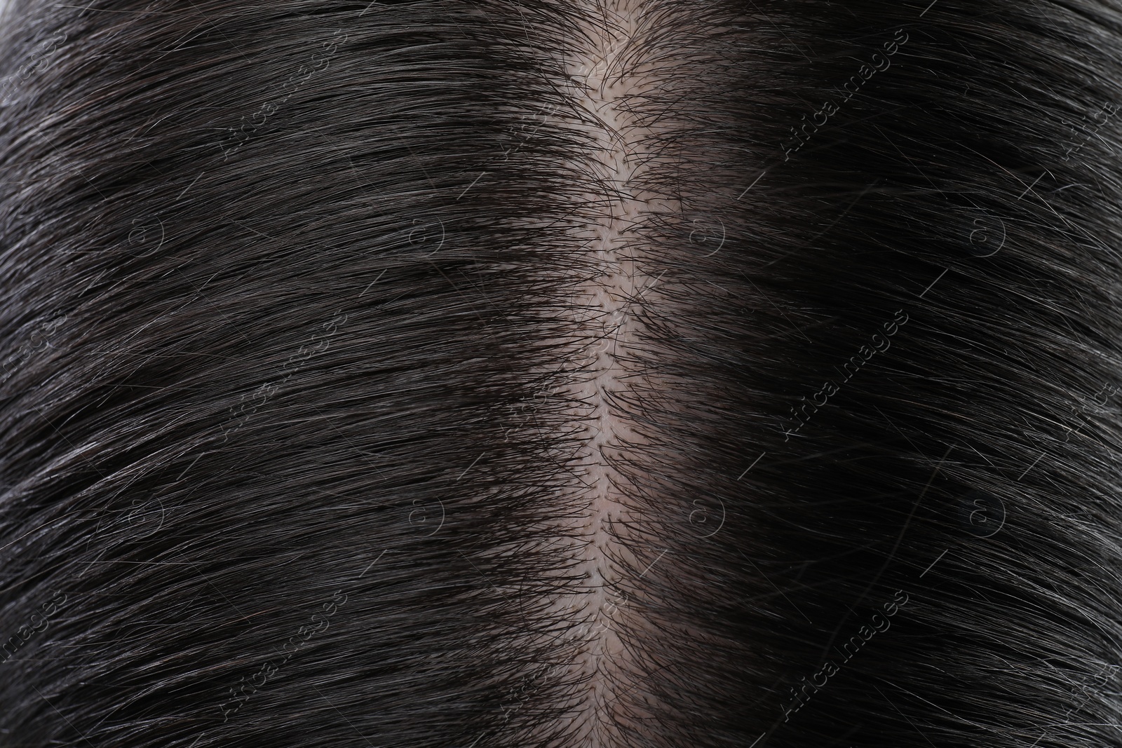 Photo of Closeup view of healthy dark woman`s hair