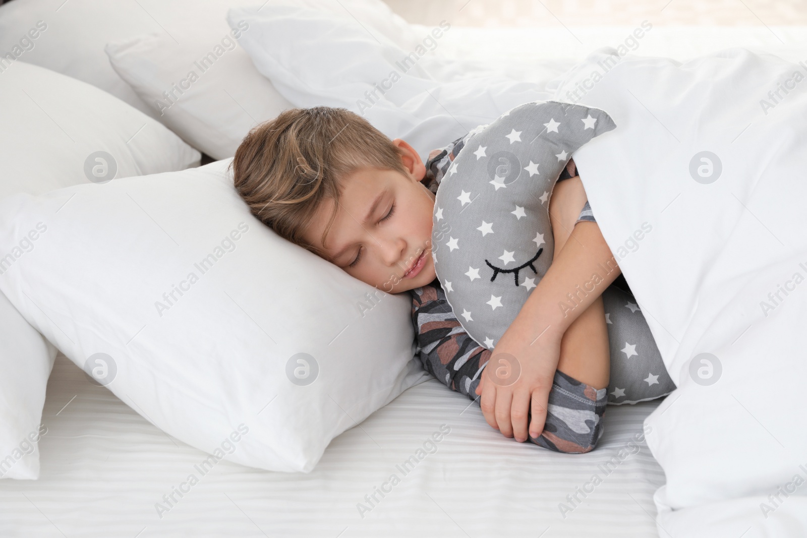 Photo of Cute boy with toy sleeping in bed