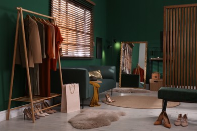 Photo of Modern dressing room interior with stylish furniture and mirror