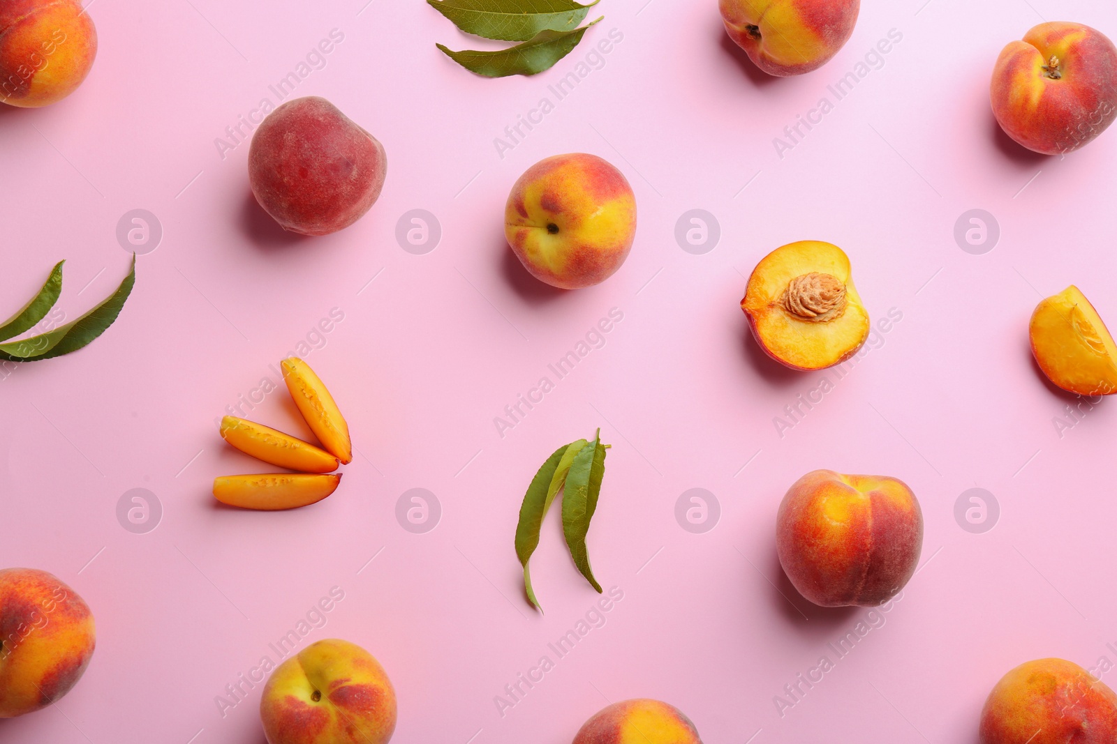 Photo of Flat lay composition with fresh peaches on pink background