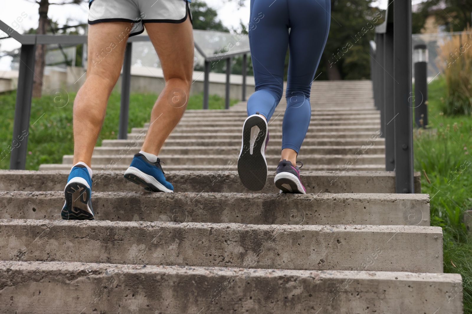 Photo of Healthy lifestyle. Couple running up stairs outdoors, closeup