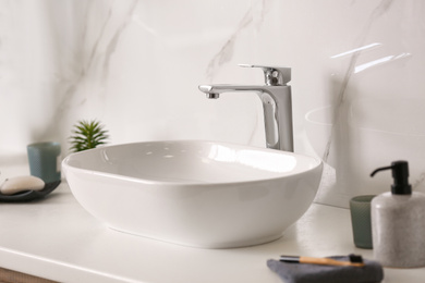 Photo of Stylish vessel sink on light countertop in modern bathroom