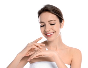 Photo of Young woman applying cream on her hand against white background. Beauty and body care