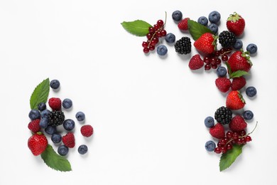 Photo of Many different fresh berries and mint leaves on white background, flat lay. Space for text