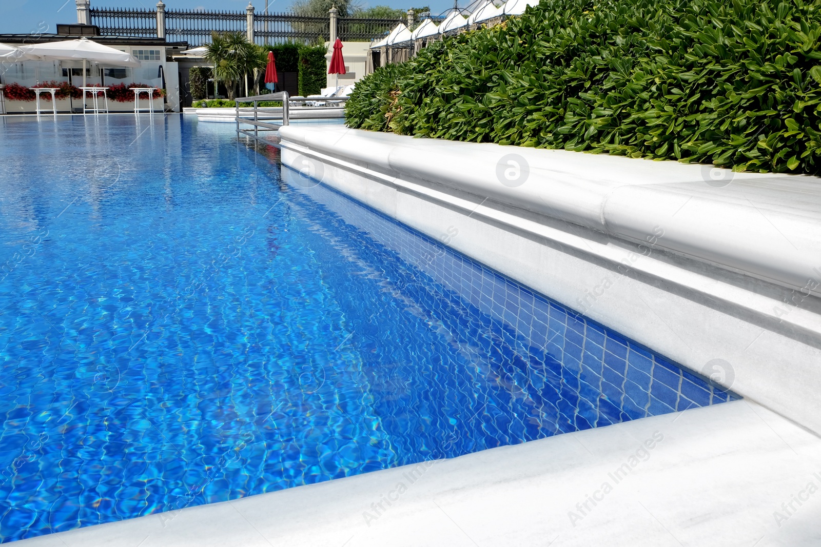 Photo of Outdoor swimming pool at sea resort on sunny day