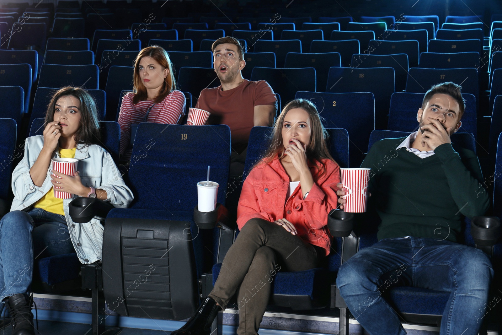 Photo of Young people watching movie in cinema theatre