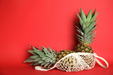 Photo of Fresh ripe juicy pineapples on red background