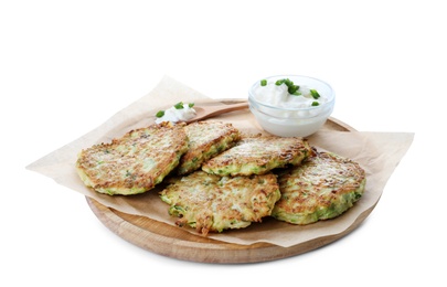 Photo of Delicious zucchini fritters with sour cream on white background
