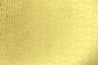 Blank golden puzzle as background, top view