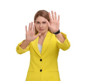 Beautiful emotional businesswoman avoiding something on white background