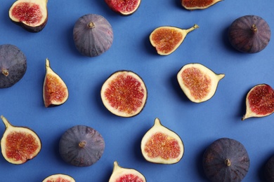 Photo of Delicious ripe figs on blue background, flat lay