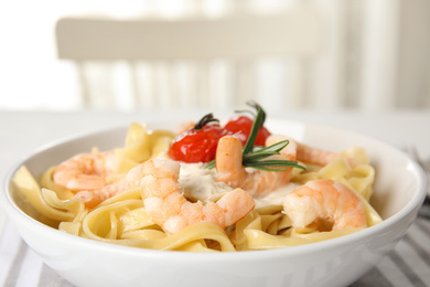 Delicious pasta with shrimps on table, closeup