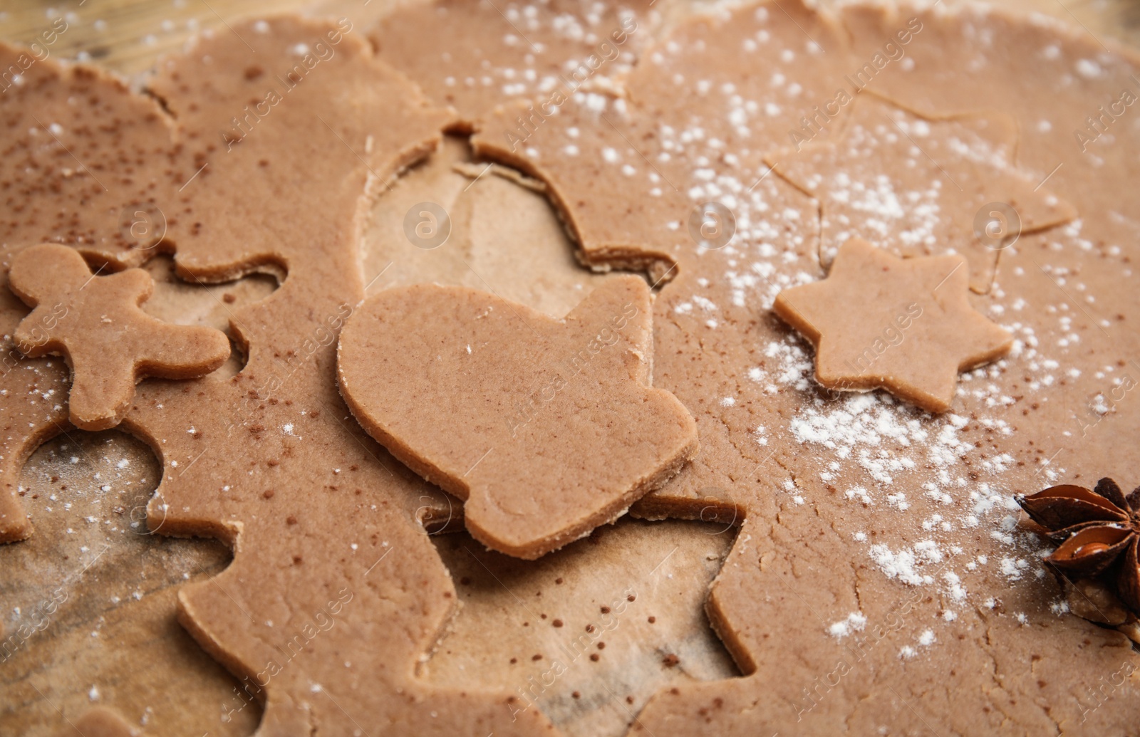 Photo of Making Christmas cookies. Raw dough and anise on table, closeup