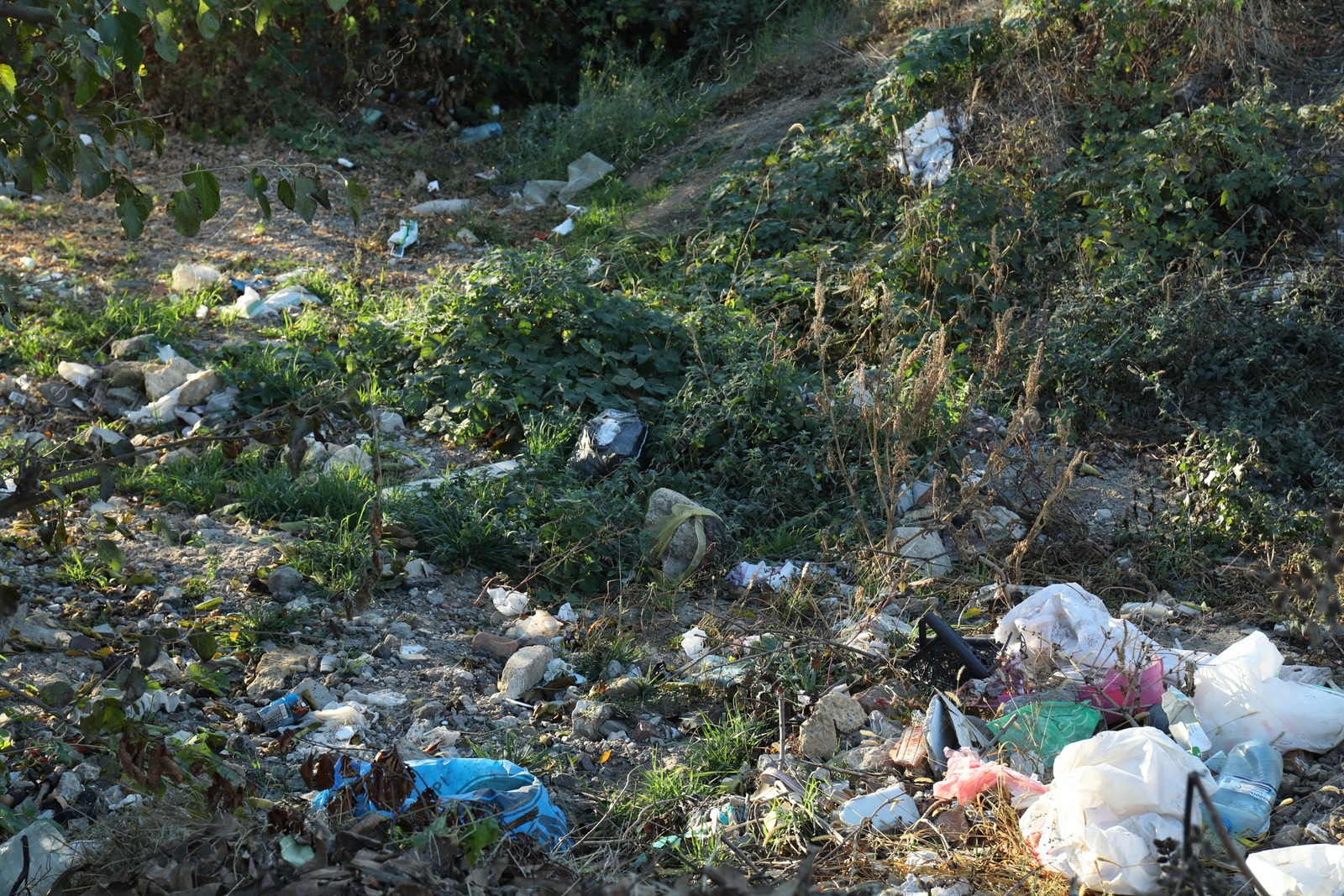 Photo of Different plastic garbage outdoors. Environmental pollution concept