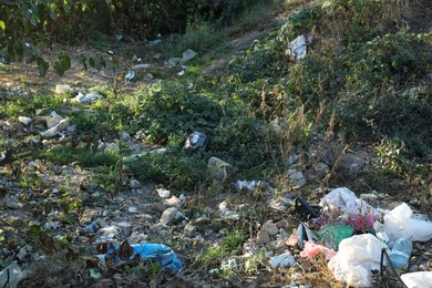 Photo of Different plastic garbage outdoors. Environmental pollution concept