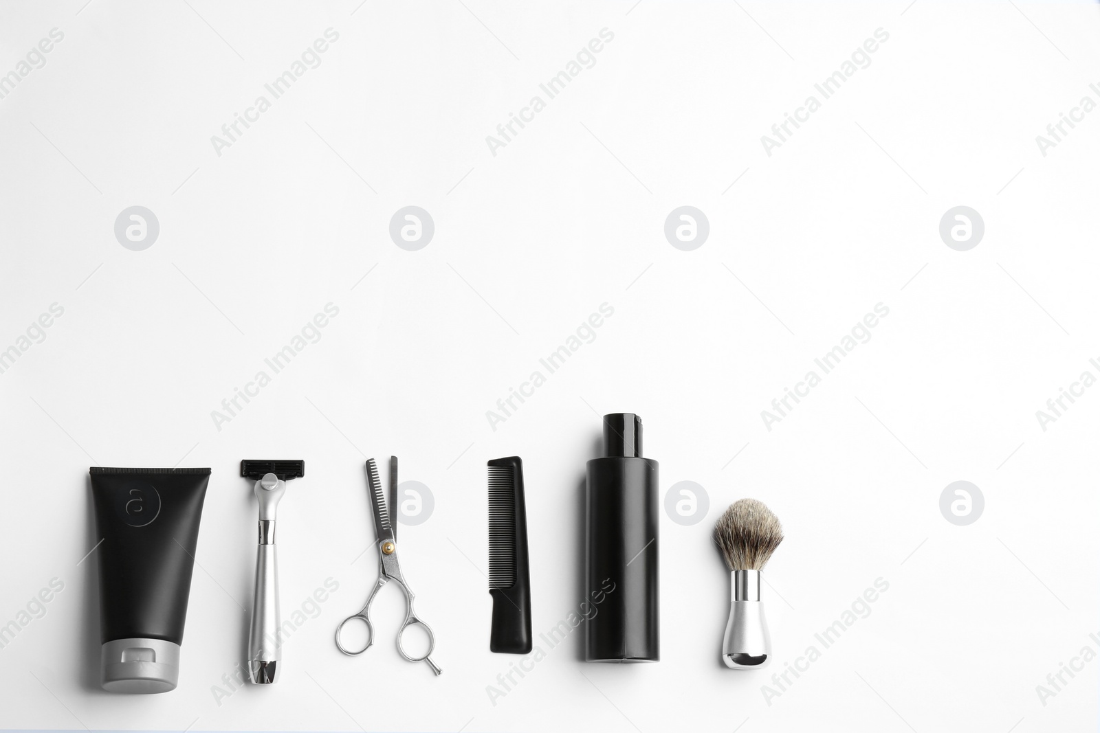 Photo of Set of barber's equipment and men's cosmetic products on light background, top view. Space for design