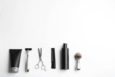 Photo of Set of barber's equipment and men's cosmetic products on light background, top view. Space for design