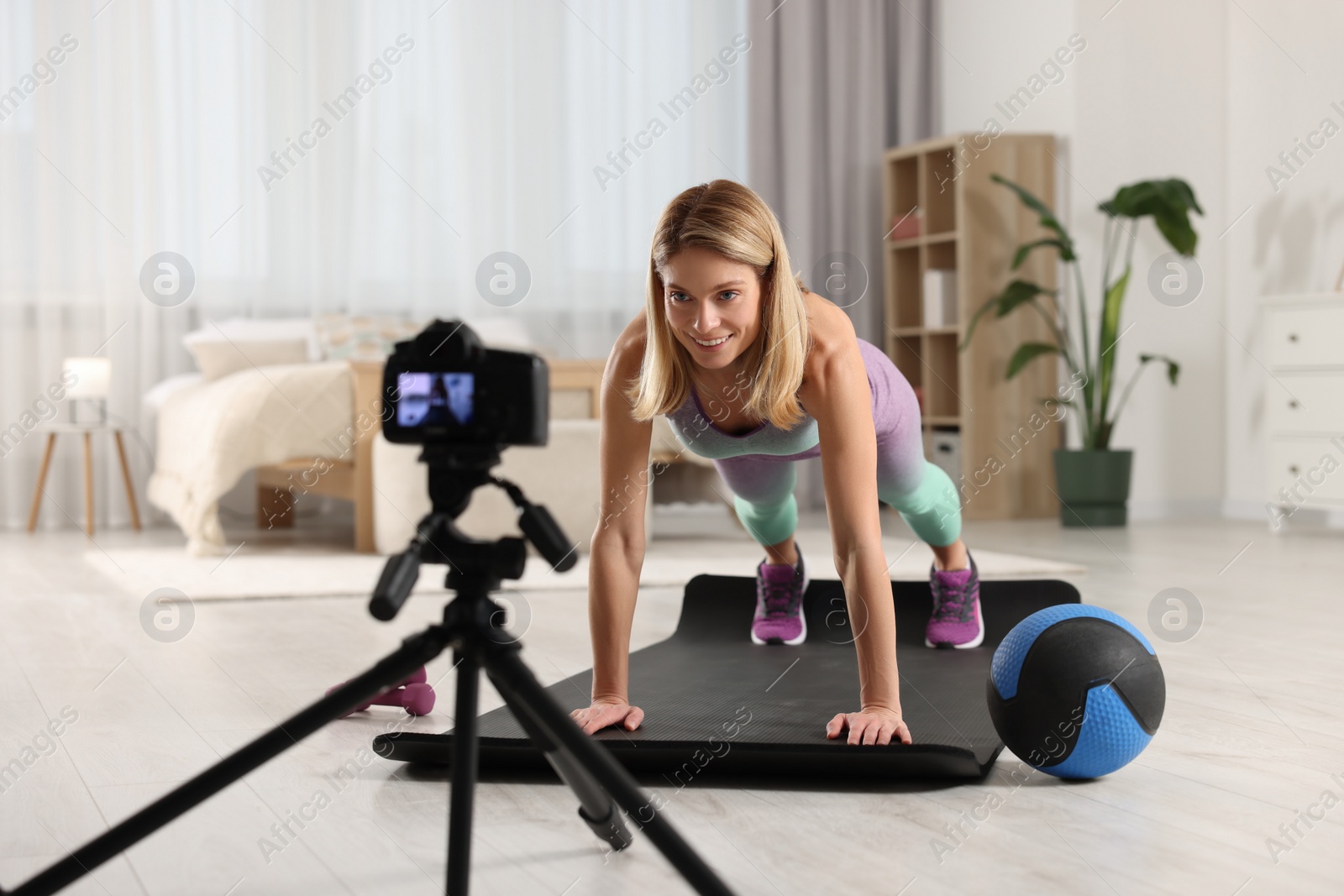 Photo of Fitness trainer recording online classes at home