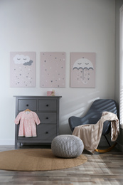 Photo of Baby room interior with cute posters and rocking chair