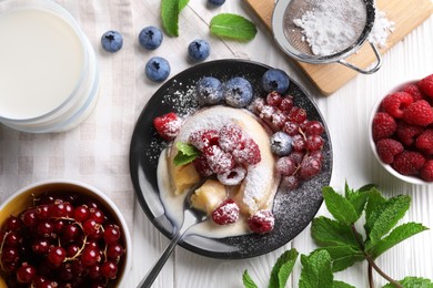 Delicious vanilla fondant served with fresh berries on white wooden table, flat lay