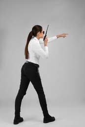 Photo of Female security guard using portable radio transmitter on color background