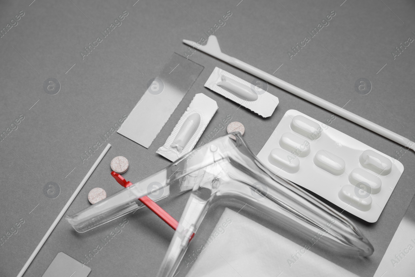 Photo of Sterile gynecological examination kit and medicaments on grey background