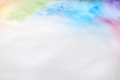 Colorful paints on white paper. Abstract background